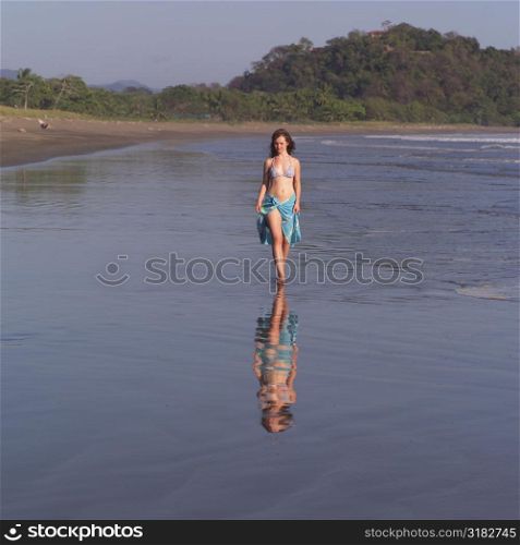 Teenage girl walking through water