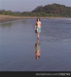 Teenage girl walking through water