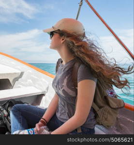 Teenage girl wearing a cap on a boat in sea, Jalisco, Mexico