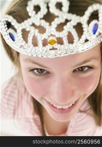 Teenage girl wearing crown and smiling