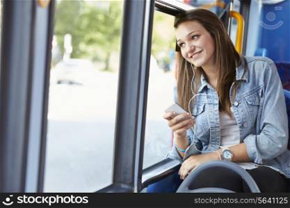 Teenage Girl Wearing Earphones Listening To Music On Bus