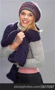 Teenage Girl Wearing Warm Winter Clothes In Studio