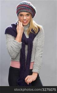 Teenage Girl Wearing Warm Winter Clothes In Studio