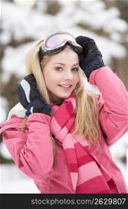 Teenage Girl Wearing Winter Clothes In Snowy Landscape