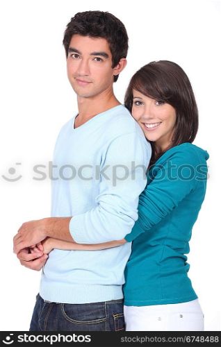 Teenage girl with arms around boyfriend