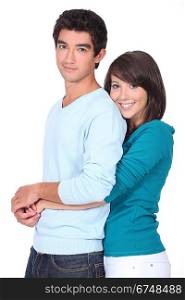Teenage girl with arms around boyfriend