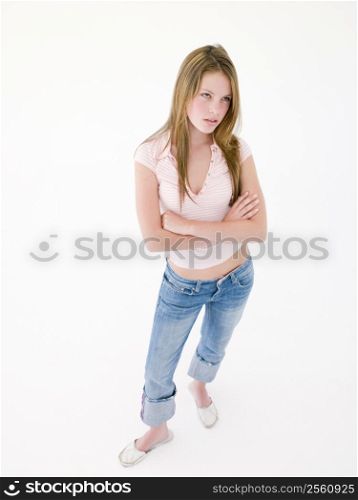 Teenage girl with arms crossed frowning