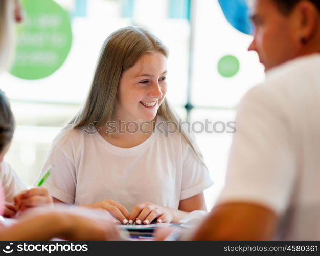 Teenage girl with books studying in library. Teenage girl with books