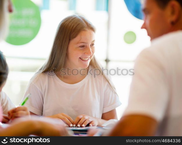 Teenage girl with books studying in library. Teenage girl with books