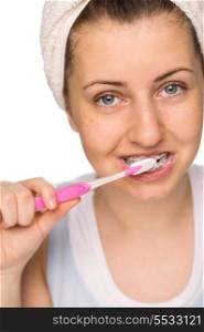Teenage girl with braces brushing teeth on white background