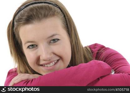 Teenage girl with brown hair smiling at camera