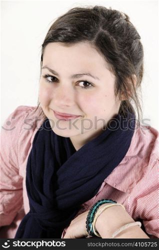 Teenage girl with brown hair smiling at camera