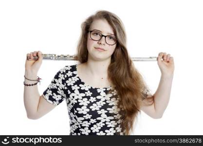 teenage girl with glasses holds flute in studio against white background