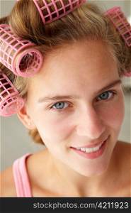 Teenage girl with hair in curlers