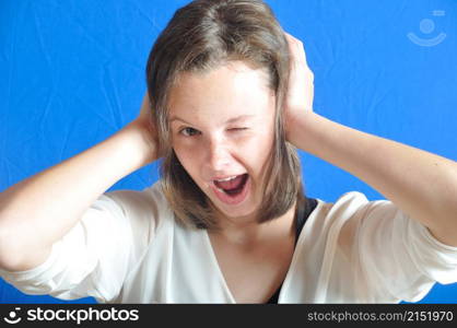 Teenage girl with her hands on her ears.