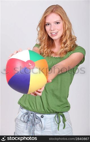 Teenage girl with inflatable beach ball