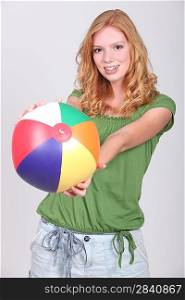 Teenage girl with inflatable beach ball