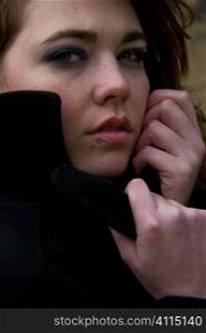 Teenage girl with lip piercing and winter coat