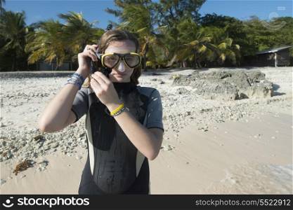 Teenage girl with scuba mask on the beach, Utila, Bay Islands, Honduras