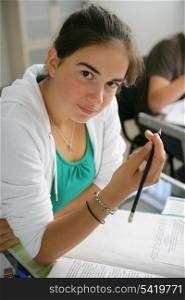 Teenage girl writing in an exam