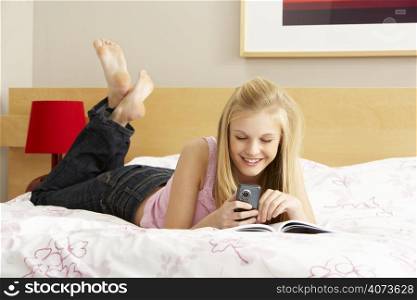 Teenage Girl Writing In Diary In Bedroom