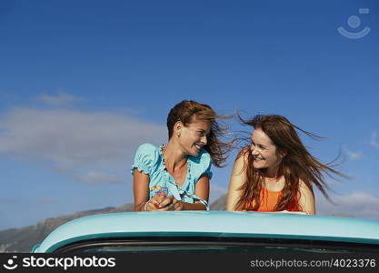 Teenage girls on back of pickup truck