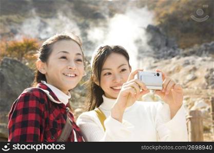 Teenage girls smiling and taking photos