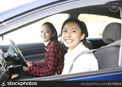 Teenage girls smiling in a car