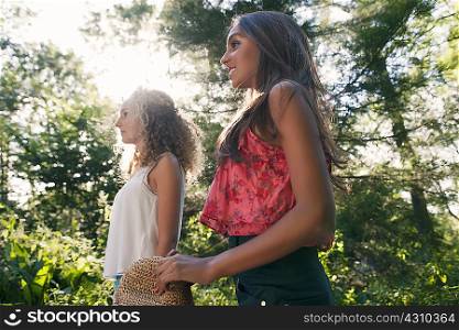 Teenage girls walking in forest
