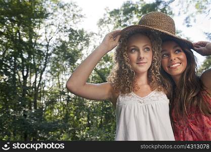 Teenage girls wearing straw hat outdoors