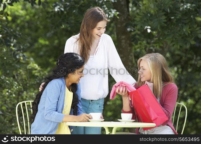 Teenage Girls With Shopping Bags At Outdoor cafe