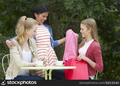 Teenage Girls With Shopping Bags At Outdoor cafe