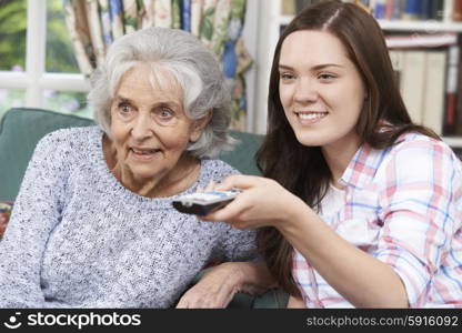 Teenage Granddaughter Watching Television With Grandmother