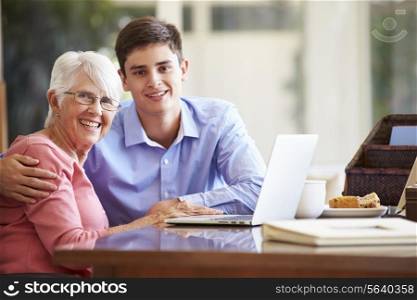 Teenage Grandson Helping Grandmother With Laptop