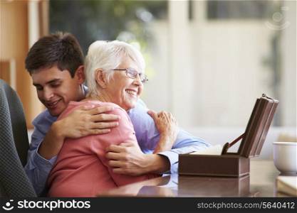 Teenage Grandson Hugging Grandmother