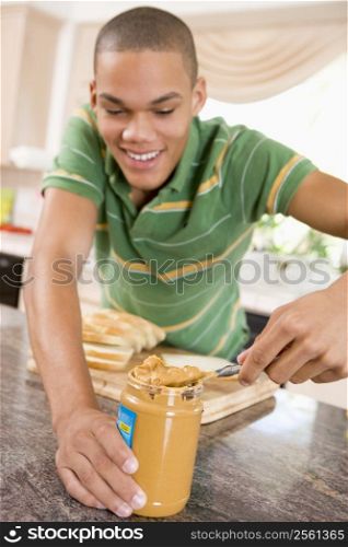 Teenage Male Making Peanut Butter Sandwich