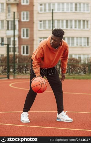teenage playing basketball outdoors