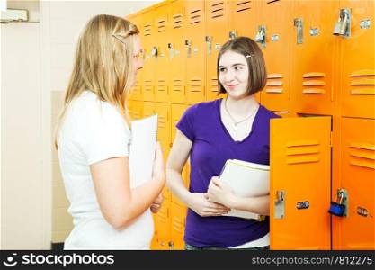 Teenage school girls talking together in the hallway between classes.