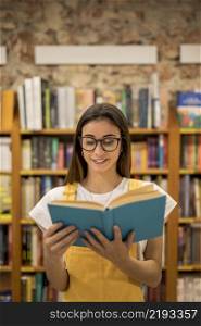 teenage schoolgirl looking library book
