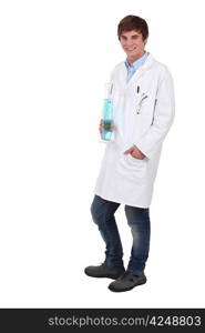 Teenage science student holding beaker full of blue liquid