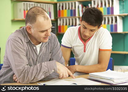 Teenage Student In Classroom With Tutor