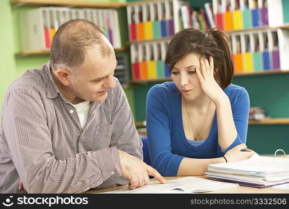 Teenage Student In Classroom With Tutor