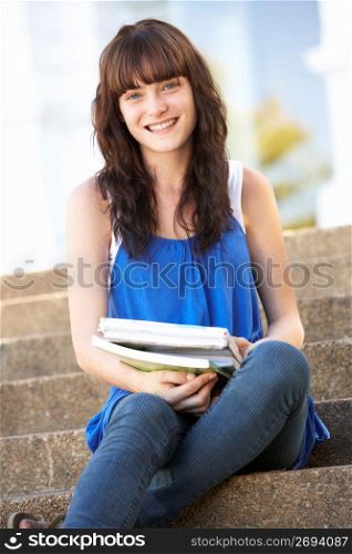 Teenage Student Sitting Outside On College Steps