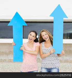 Teenage students holding blue arrows and pointing in diferent directions