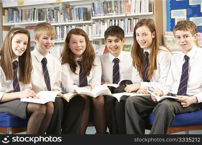 Teenage Students In Library Reading Books