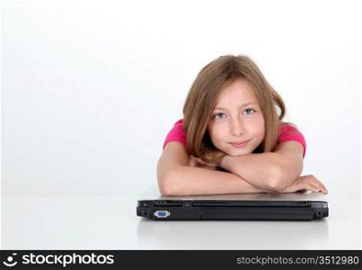 Teenaged girl with arms crossed on laptop computer