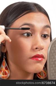. Teenager Applying Mascara To Her Eyelashes