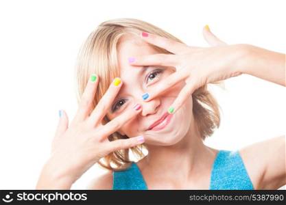 Teenager blonde girl&#39;s face with multicoloured nails close up