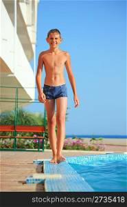 teenager boy going near pool pool against sea