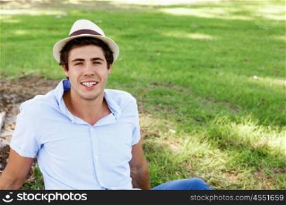 Teenager boy in the park. Teenager boy in the park sitting on grass